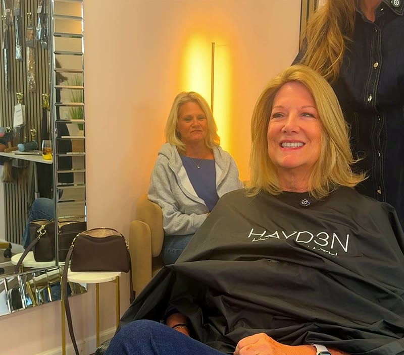 After: her hair full and styled, smiling